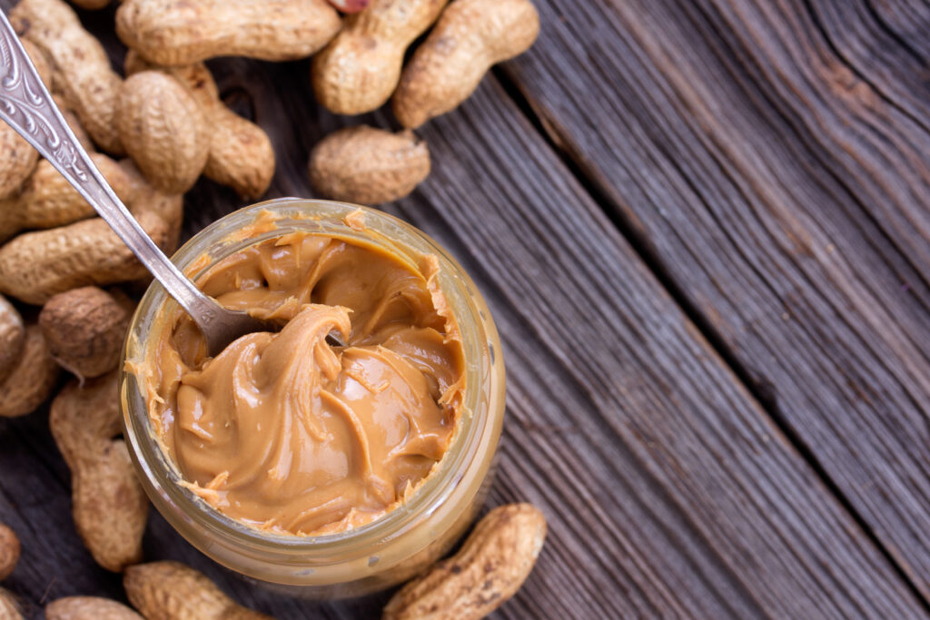 Processed foods, like the peanut butter shown in this image, play a critical role in meeting food nutrition and safety needs.